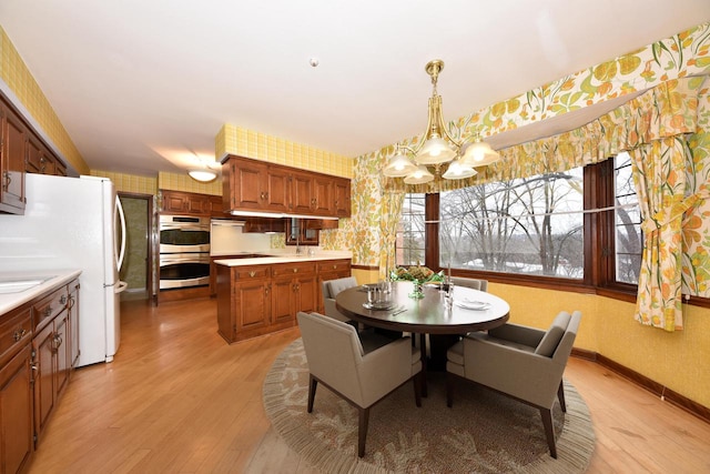 dining room featuring light hardwood / wood-style flooring and a notable chandelier