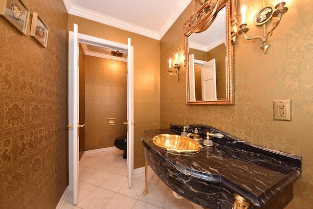 bathroom with crown molding, sink, tile patterned floors, and toilet