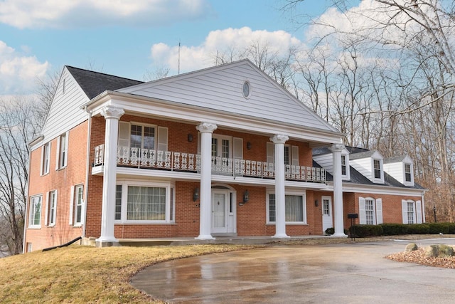 neoclassical home with a balcony