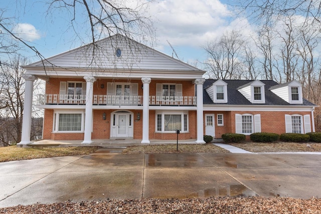 greek revival house with a balcony