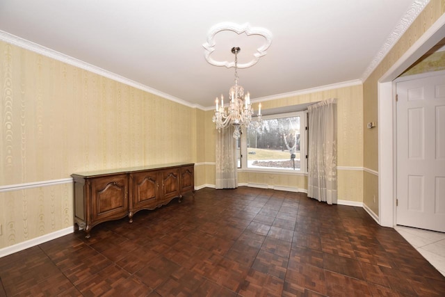 unfurnished dining area featuring ornamental molding, dark parquet floors, and an inviting chandelier