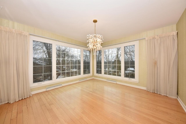 interior space with a baseboard radiator and a chandelier