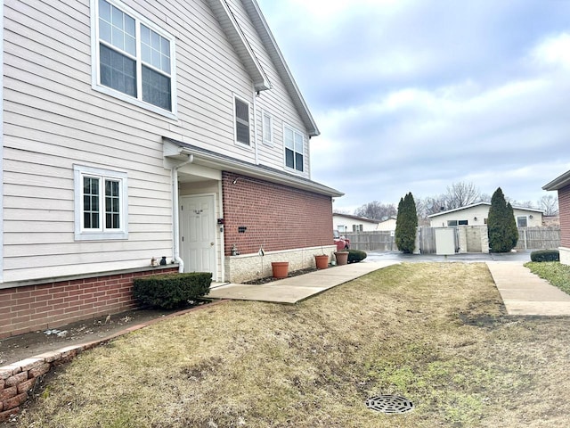 view of side of property featuring a patio and a yard