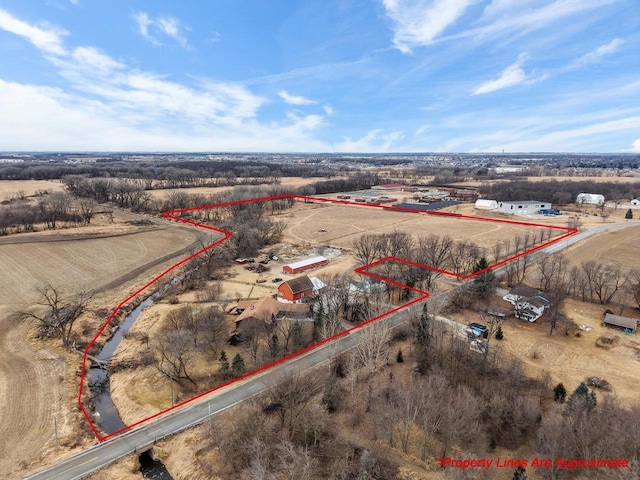 birds eye view of property featuring a rural view