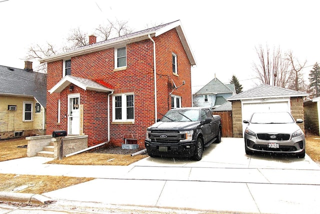 view of property featuring a garage and an outdoor structure