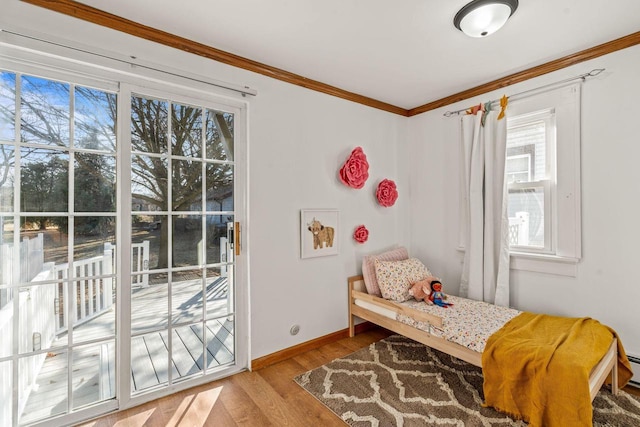 bedroom with crown molding, access to exterior, and light hardwood / wood-style floors