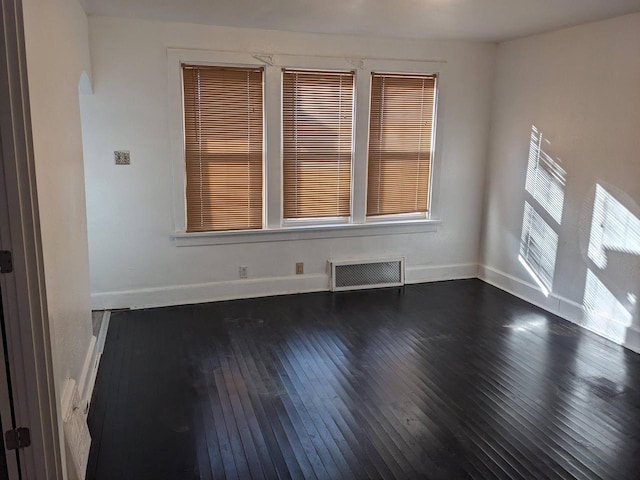 unfurnished room featuring dark hardwood / wood-style floors