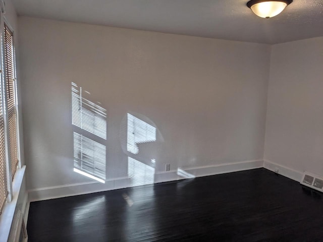 spare room with wood-type flooring and a textured ceiling