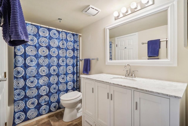 bathroom featuring vanity and toilet