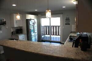 kitchen with decorative light fixtures and stainless steel refrigerator