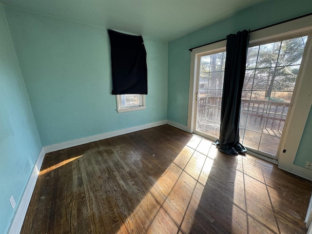 unfurnished room with wood-type flooring