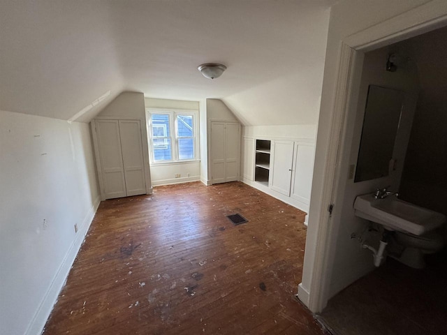 bonus room featuring lofted ceiling and dark hardwood / wood-style floors