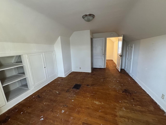 additional living space with lofted ceiling and dark hardwood / wood-style floors