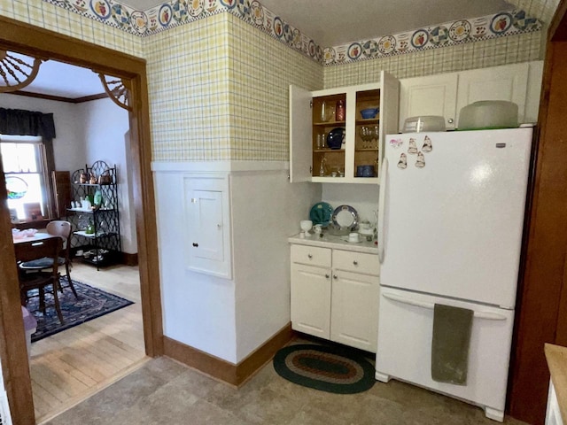 kitchen featuring white cabinetry and white fridge