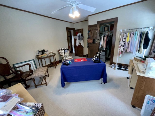 bedroom with ornamental molding, light colored carpet, ceiling fan, and a closet