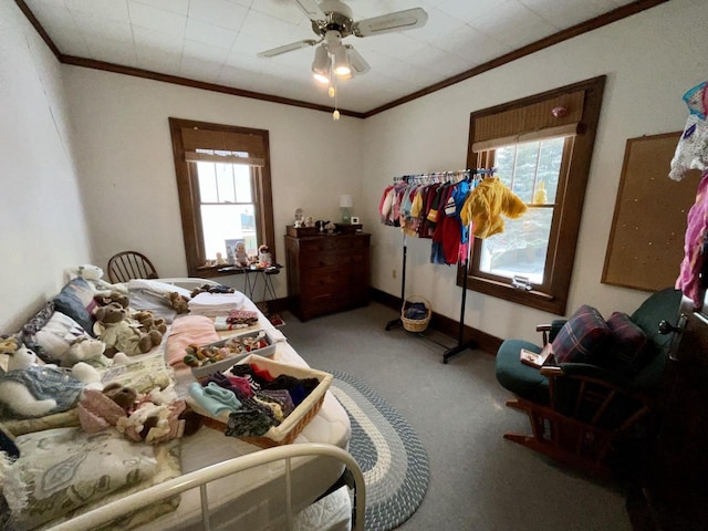 carpeted bedroom featuring ornamental molding and ceiling fan