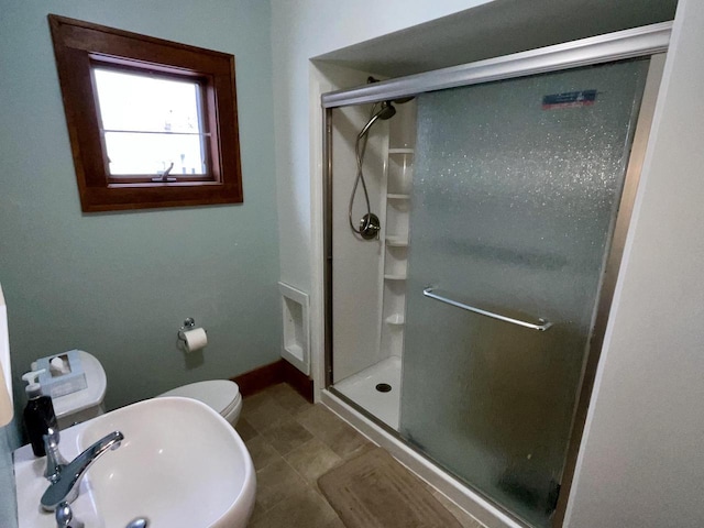 bathroom with toilet, sink, and walk in shower