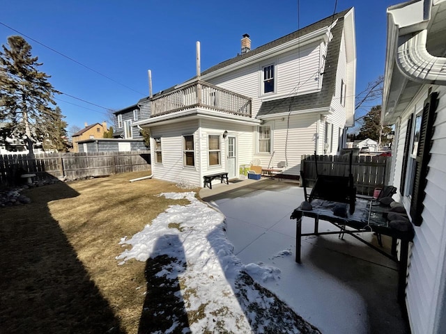 rear view of property with a balcony and a patio