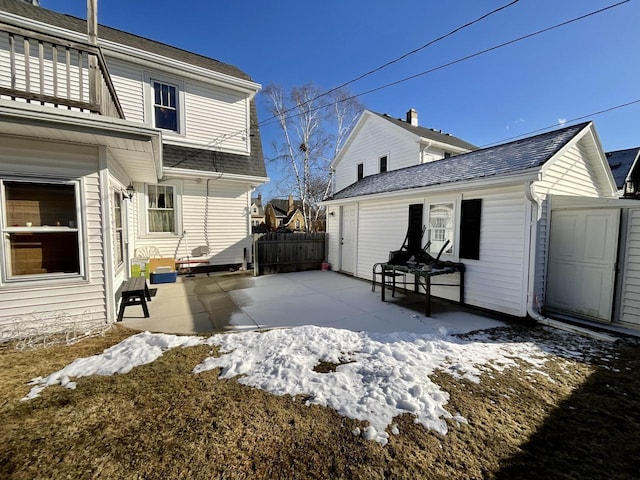 view of snow covered exterior with a patio