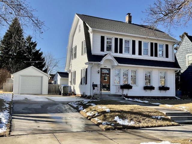 view of front of house with a garage and an outdoor structure