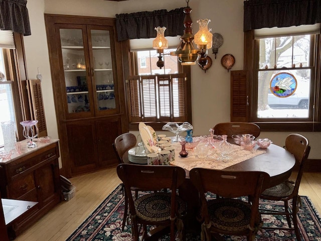 dining area featuring plenty of natural light, a chandelier, and light wood-type flooring