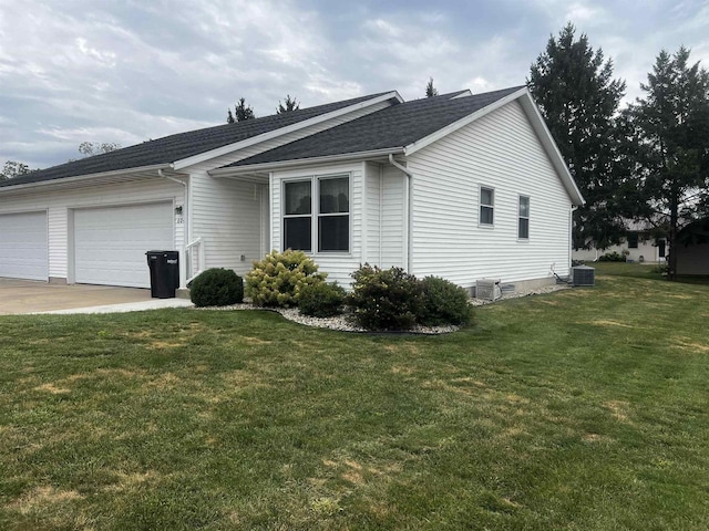 view of home's exterior with a yard, a garage, and central AC unit