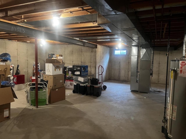 basement featuring water heater and heating unit