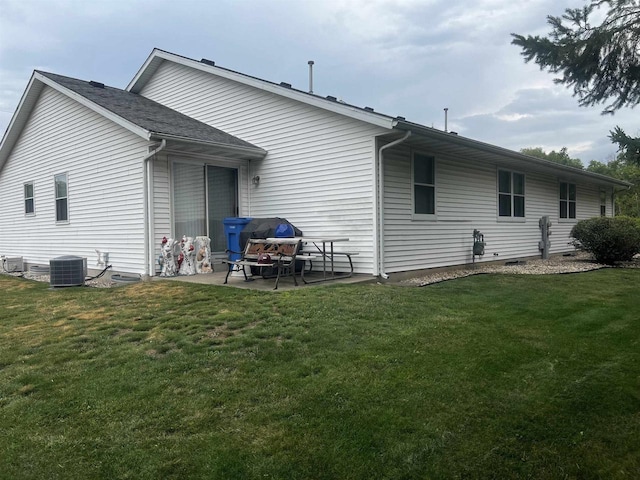 back of property featuring central AC, a patio area, and a lawn