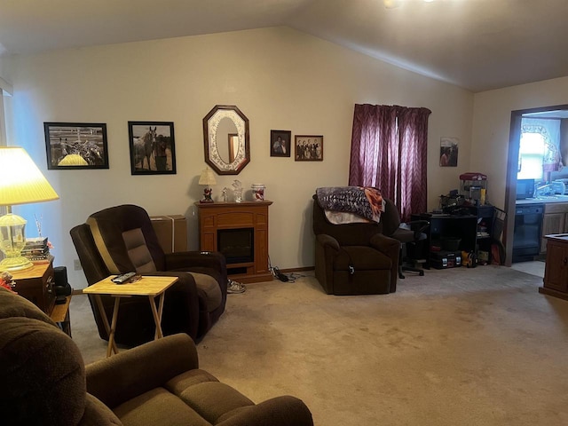 carpeted living room with lofted ceiling