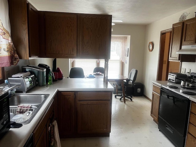 kitchen featuring electric stove, sink, range hood, dark brown cabinetry, and kitchen peninsula