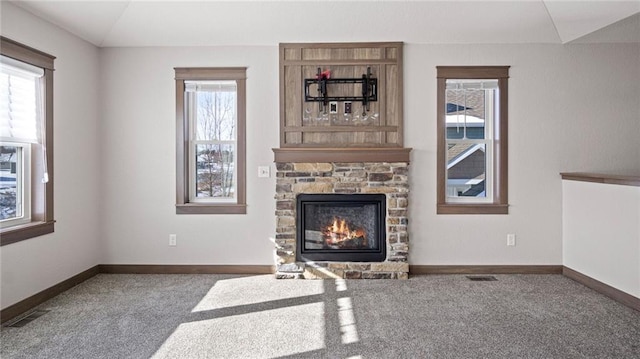 carpeted living room featuring vaulted ceiling and a fireplace