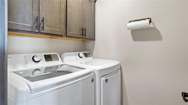 laundry area featuring cabinets and washer and dryer