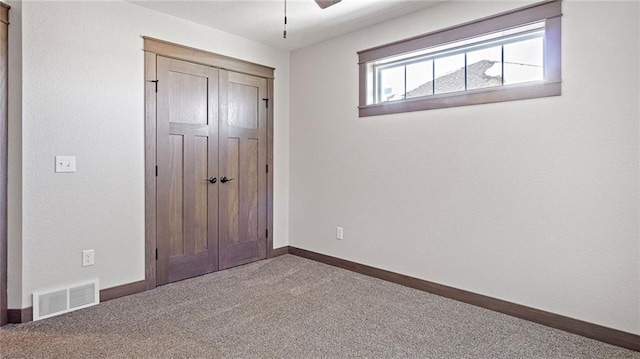 unfurnished bedroom with carpet floors and a closet