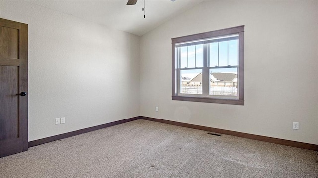 empty room with carpet, lofted ceiling, and ceiling fan