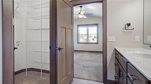 bathroom with vanity and vaulted ceiling