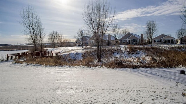 snowy yard with a water view