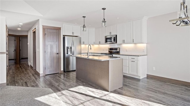 kitchen featuring pendant lighting, sink, a kitchen island with sink, stainless steel appliances, and white cabinets