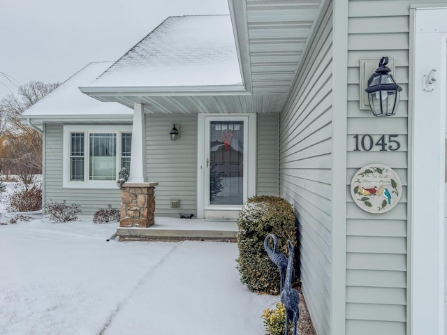 view of snow covered property entrance