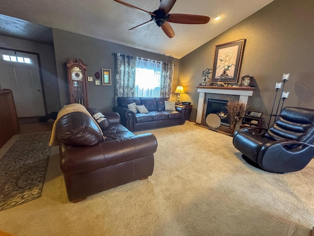 living room with ceiling fan, plenty of natural light, carpet flooring, and vaulted ceiling