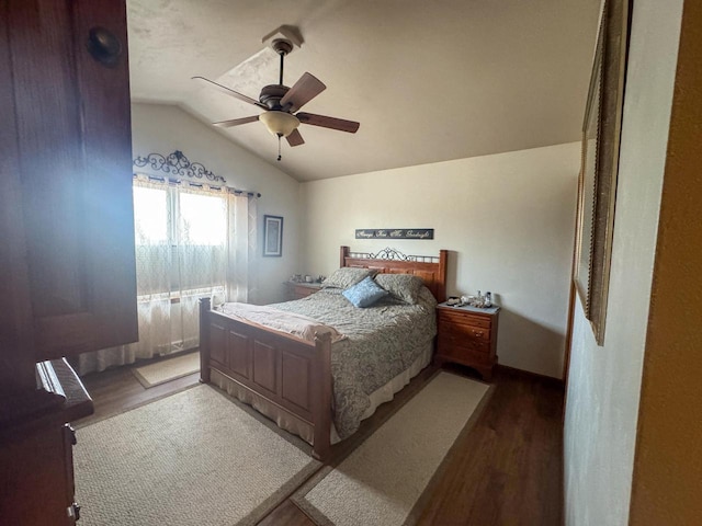 bedroom featuring ceiling fan, lofted ceiling, and dark hardwood / wood-style flooring