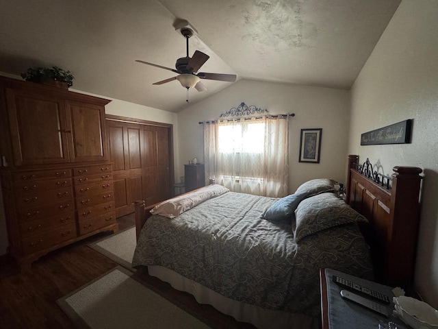 bedroom featuring dark hardwood / wood-style flooring, vaulted ceiling, a closet, and ceiling fan