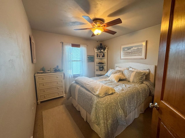 bedroom with dark colored carpet and ceiling fan