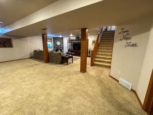 basement featuring a fireplace and carpet