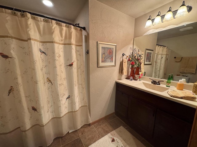 bathroom with vanity and a textured ceiling