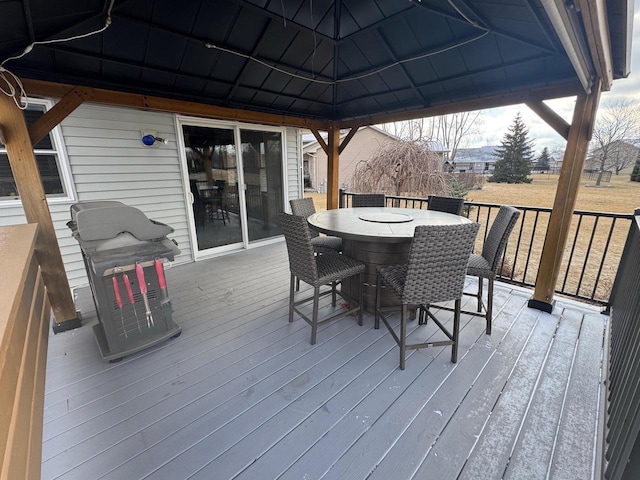 wooden terrace featuring a gazebo