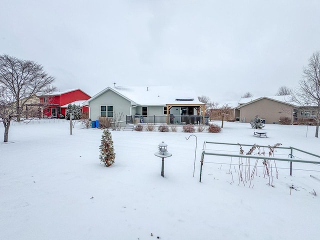 view of snow covered rear of property