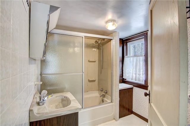 bathroom featuring vanity and shower / bath combination with glass door