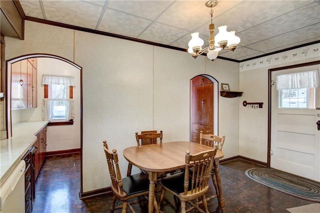 dining room featuring ornamental molding and an inviting chandelier