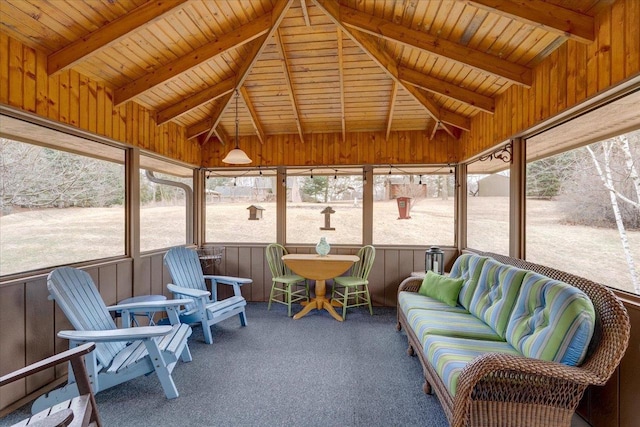 sunroom / solarium featuring vaulted ceiling with beams and wood ceiling