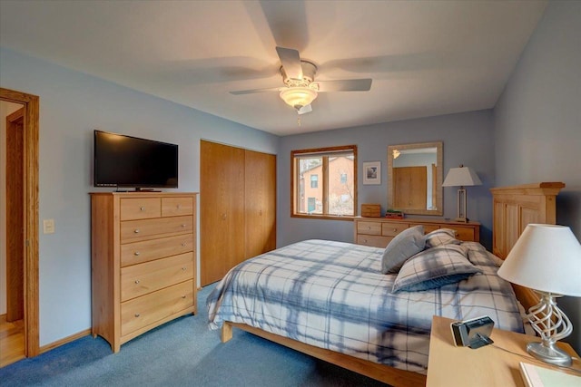 carpeted bedroom featuring ceiling fan and a closet